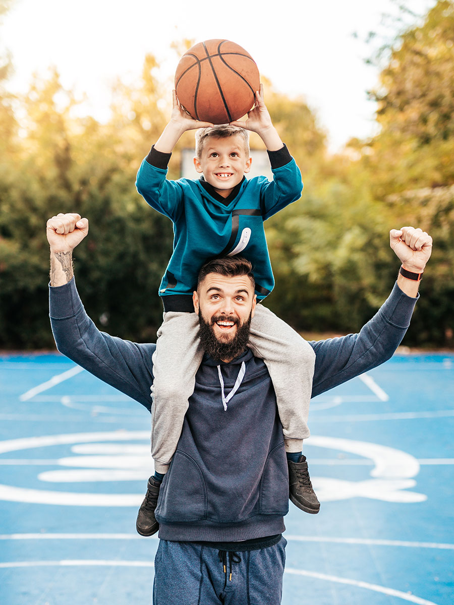 Father and son playing basketball