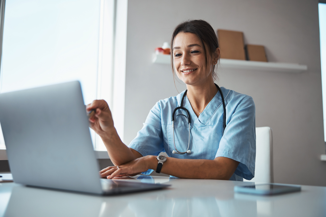 Health professional using laptop.